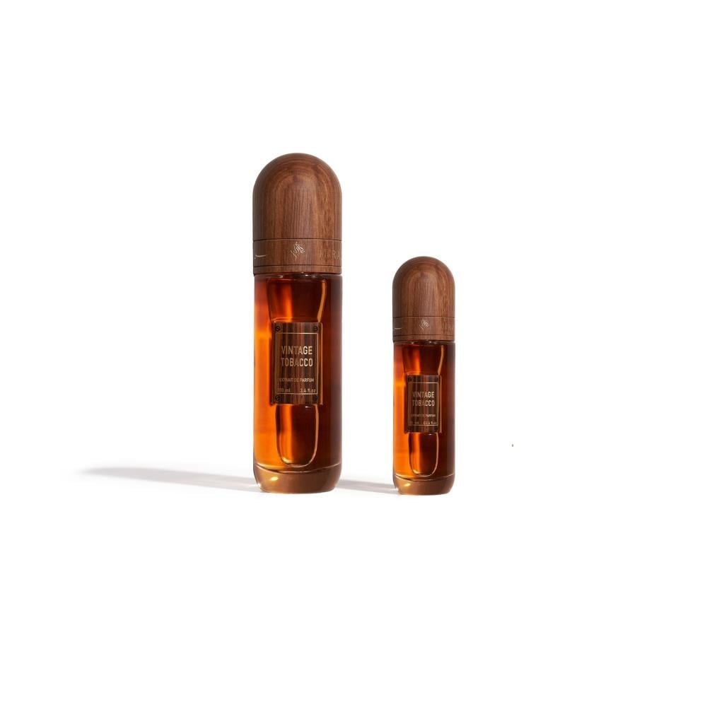 Two wooden bottles with amber liquid on a white background