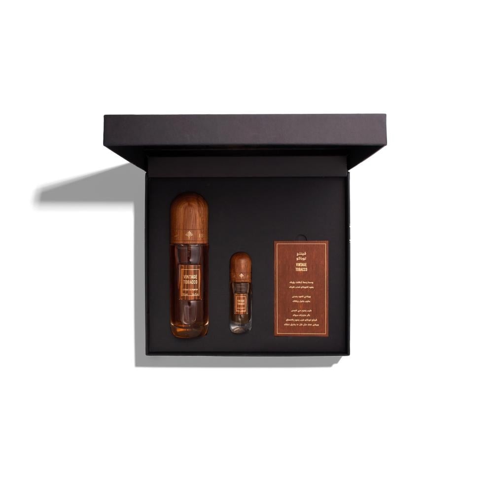 Two small bottles and a label in a black box on a white background